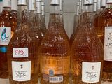several bottles of wine are lined up on a shelf