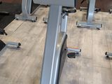 a row of stationary exercise bikes in a gym
