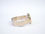a close up of a silver and gold bracelet on a white surface