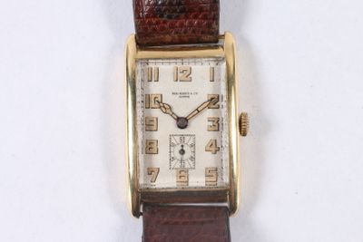 a watch that is sitting on a white surface