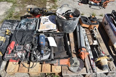 a pile of tools on a pallet on the side of the road