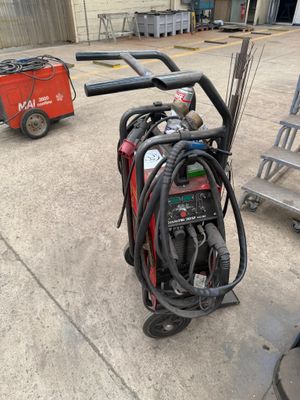 a fire extinguisor sitting on a cart in a garage