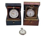 two clocks that are sitting in a wooden box