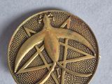 a close up of a metal object with a bird on it