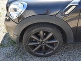 a small black car that is parked on the side of the road