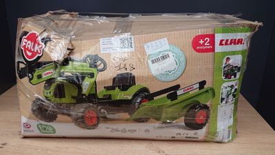 a box with a toy tractor in it sitting on a table