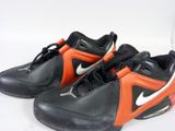 black and orange nike air max sneakers on a white surface