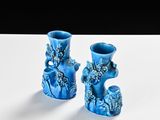 two blue vases that are sitting on a table