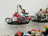 many figurines of people riding motorcycles on display
