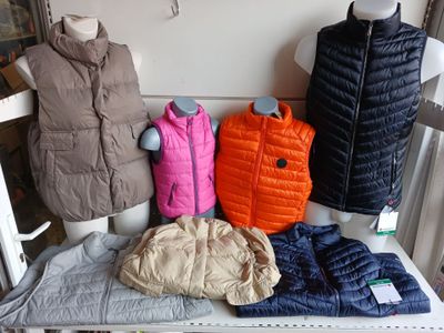 many different types of vests on display on a table