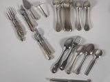 a lot of silver spoons and forks on the table