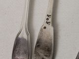 three spoons and two spoons on a table
