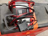 an electric forklift with a battery and a charger on top of it