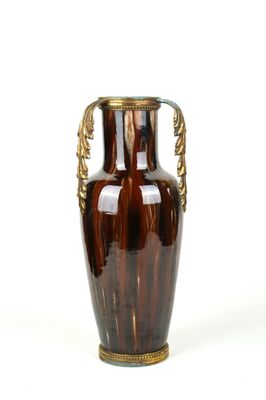 a brown vase with a gold handle on a white background