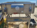 a machine that is sitting on the ground by the water