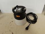 a close up of a black and white bucket with a power cord