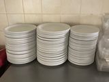a lot of white plates on the counter in the kitchen