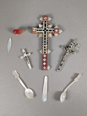 a lot of spoons and a cross on the table