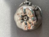 a silver ring with a flower on it on a table