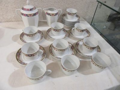 a lot of cups and saucers on the table