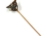 a stick with a bird on it on a white surface