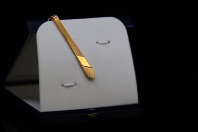 a gold pen sitting on top of a white box
