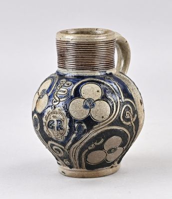a blue and white vase sitting on a white surface