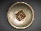a white bowl with a brown design on it