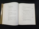 a book open on a black table with a cup of coffee