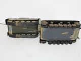 pair of old model train engines sitting side by side on a white surface