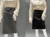 two mannequins dressed in white shirts and black skirts