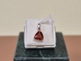 an image of a red garnet stone in a white box