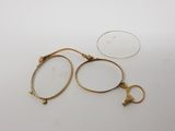 a pair of glasses sitting on top of a table next to a pair of scissors