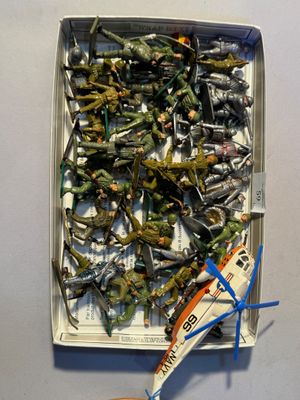 a box with a bunch of toy airplanes and a pair of scissors