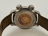 a close up of a watch on a white surface
