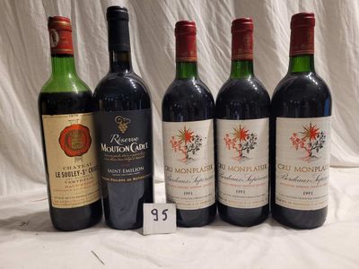 several bottles of wine are lined up on a table
