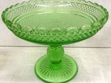 an image of a green glass pedestal bowl on a white table