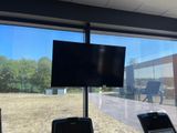 a television that is on the wall in the gym