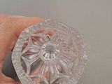 a person holding a clear glass object in their hand