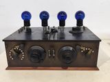 an old fashioned radio with four blue lights on top of it