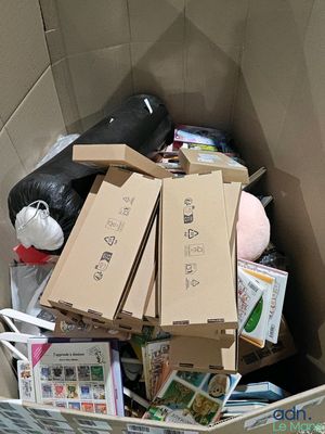 a cardboard box filled with boxes and other items