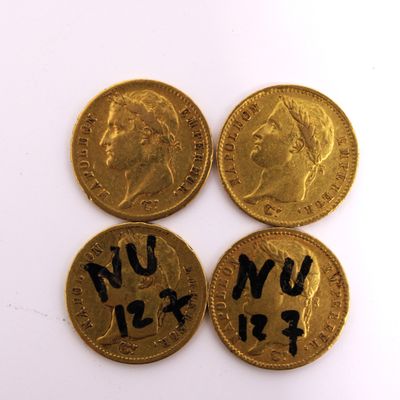 four gold coins with writing on them sitting next to each other