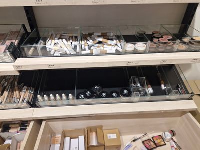 a lot of makeup products on the shelves in the store
