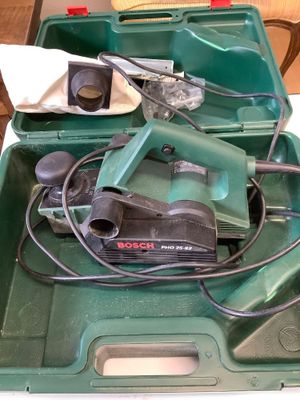 a green tool box with tools in it on a table