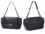 pair of black leather handbags with chain handles on a white background