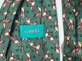 a close up of a green tie with birds on it