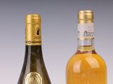 two bottles of wine sitting next to each other on a table