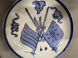 a blue and white plate with a design on it