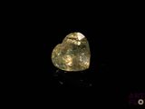 a heart shaped diamond on a black surface