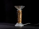 a lamp that is sitting on a table with a black background